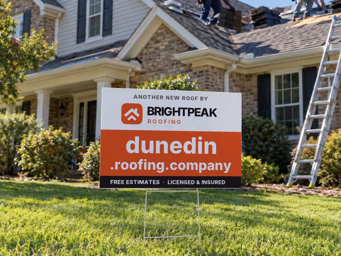 dunedin.roofing.company on a yard sign in front of a house getting a new roof